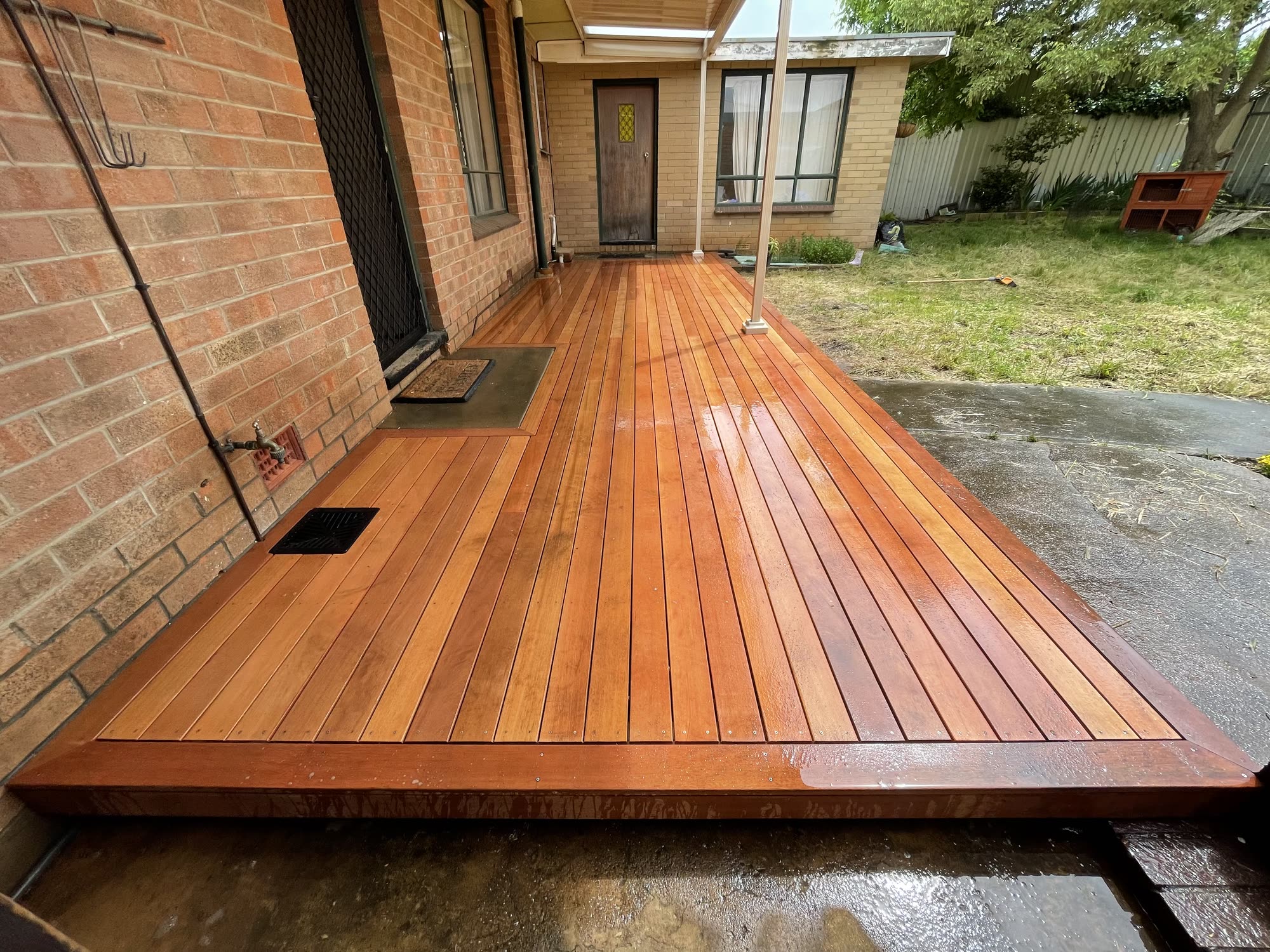 Oiled merbau deck running the length of a brick home in Adelaide