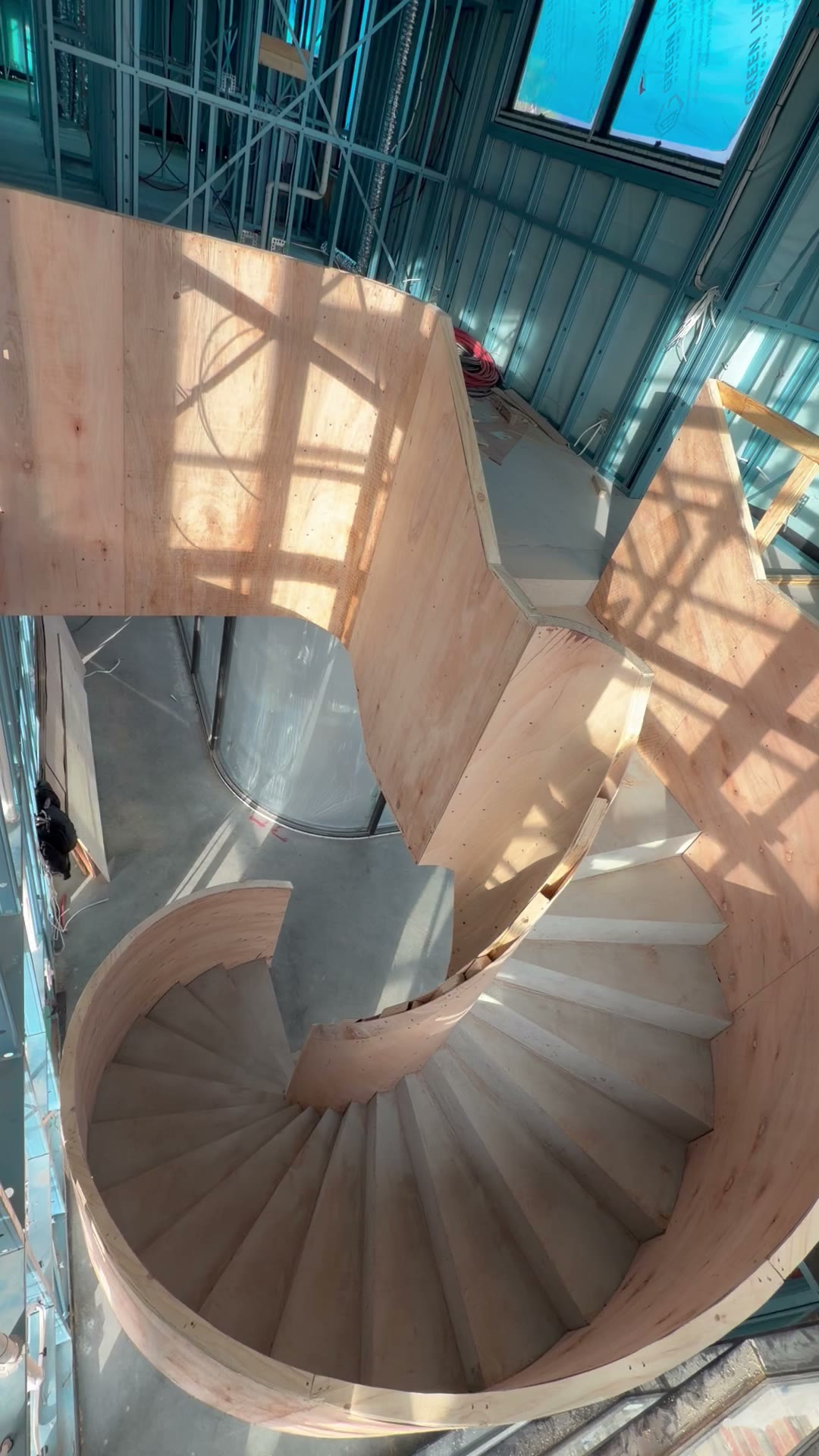 Curved plywood spiral staircase under construction, built by Russo Built
