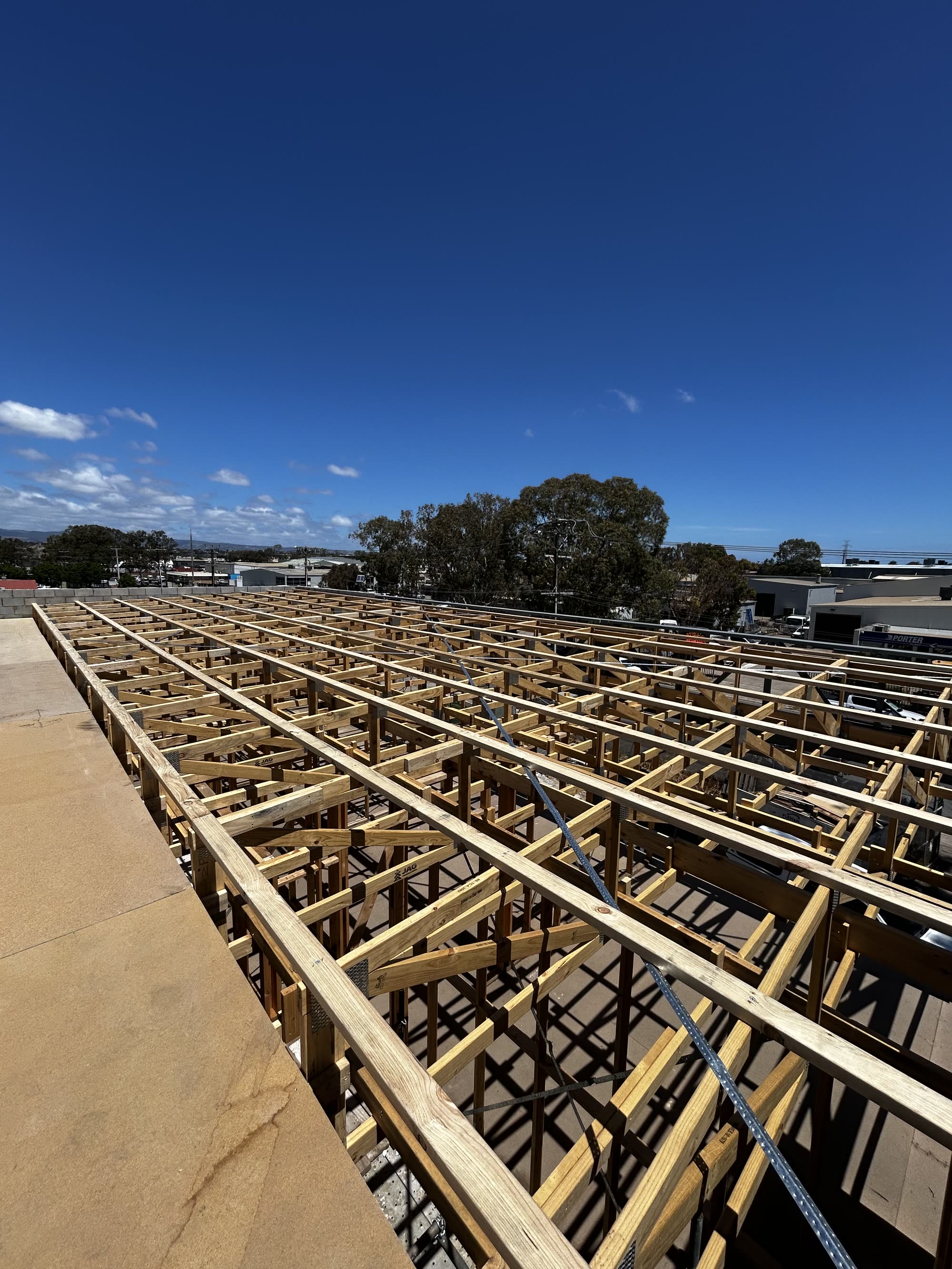 Timber bearers and joists laid out across a large subfloor